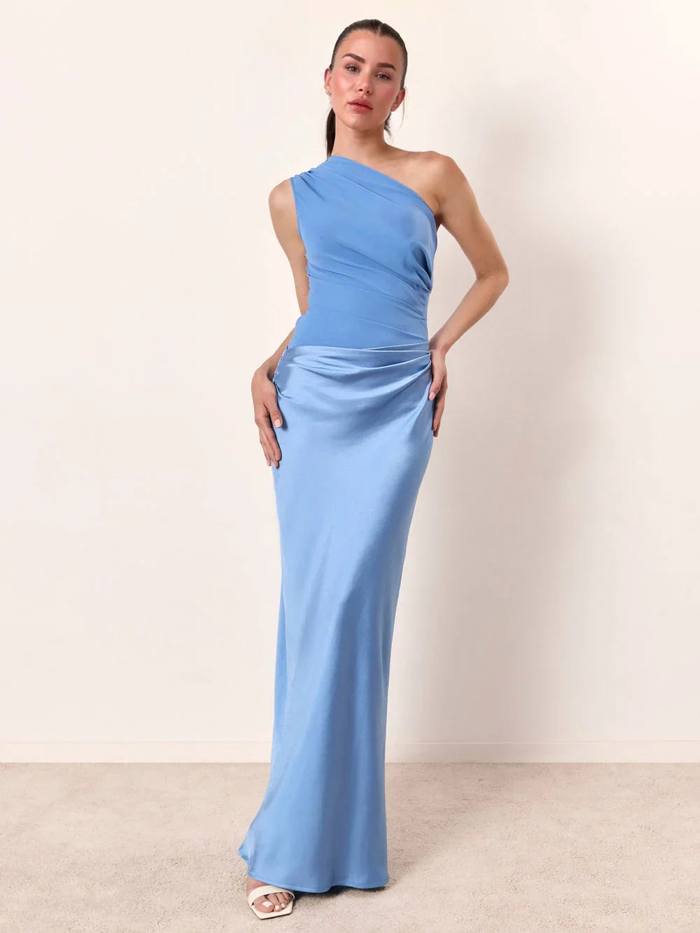 Woman wearing one-shoulder satin evening dress